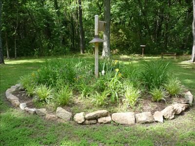 New leaves and blooms spread on the arbor in Plantation Gardens at Occoneechee. 